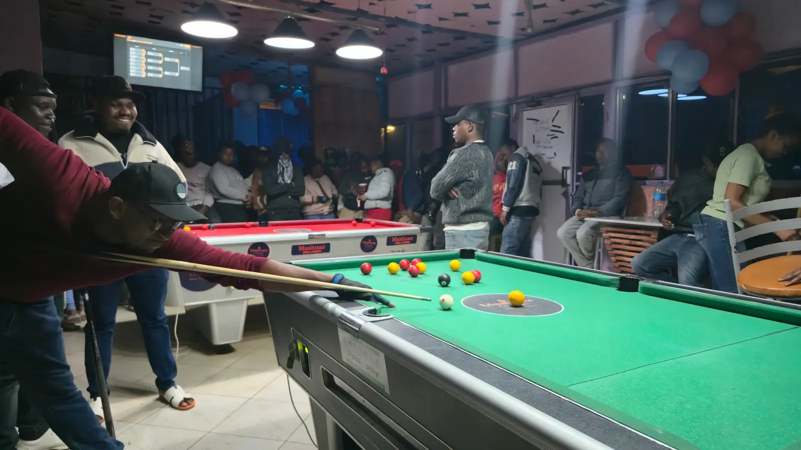 A player lining up a shot on tournament night